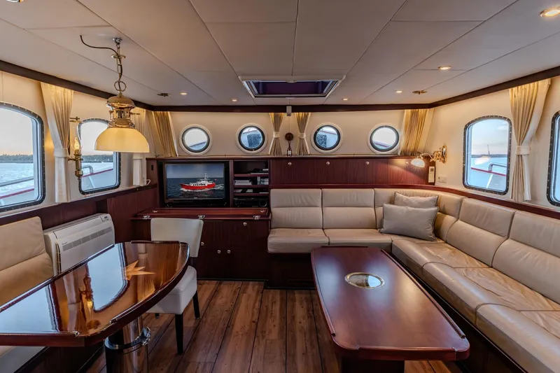 San Gottardo Yacht Photos Pics Luxurious interior of 2009 Altena Expedition yacht with elegant seating and porthole windows.