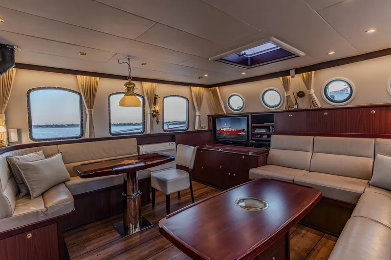 San Gottardo Yacht Photos Pics Luxurious interior of 2009 Altena Expedition yacht with elegant seating and wooden accents.