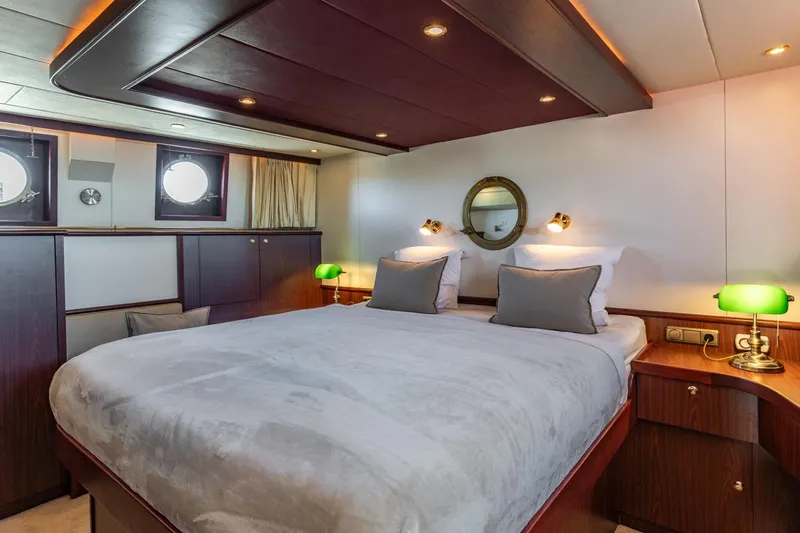 San Gottardo Yacht Photos Pics Luxurious 2009 Altena Expedition yacht bedroom with elegant wood finishes and ambient lighting.