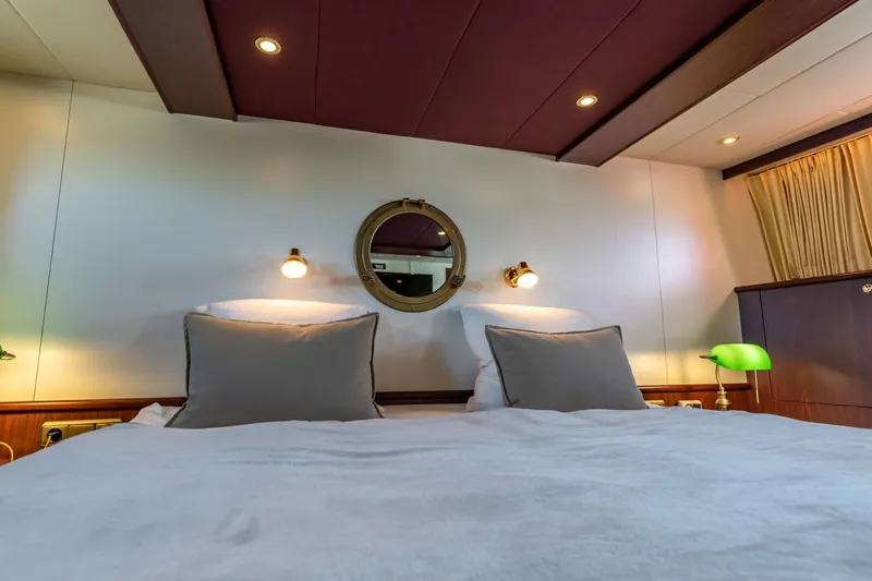 San Gottardo Yacht Photos Pics Luxurious cabin interior of 2009 Altena Expedition yacht with cozy bedding and ambient lighting.