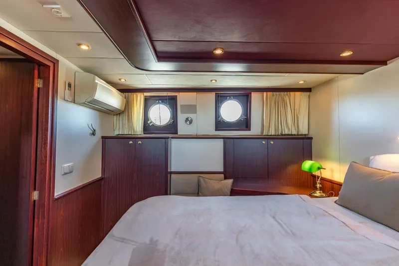 San Gottardo Yacht Photos Pics Luxurious cabin interior of 2009 Altena Expedition yacht with elegant wood finishes.