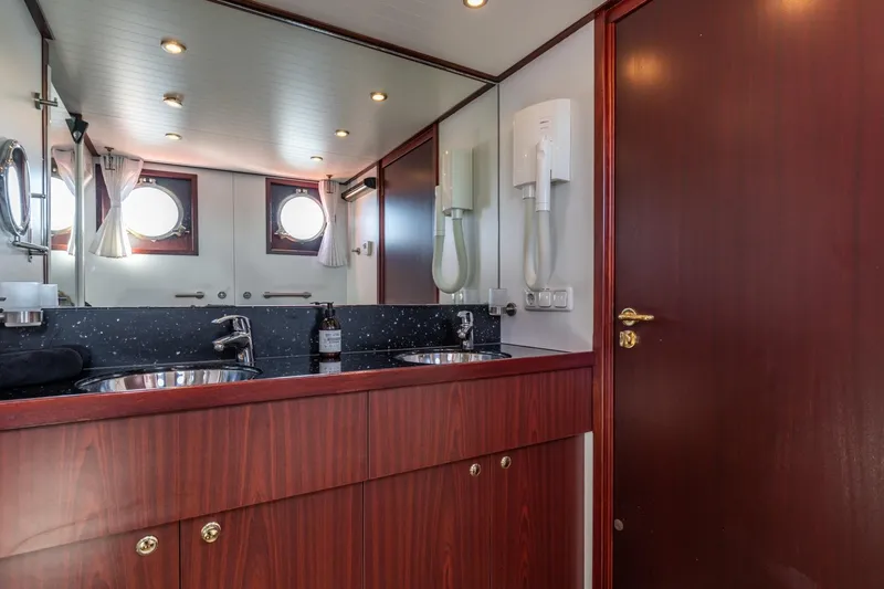 San Gottardo Yacht Photos Pics Luxurious bathroom interior of 2009 Altena Expedition yacht with dual sinks and porthole windows.