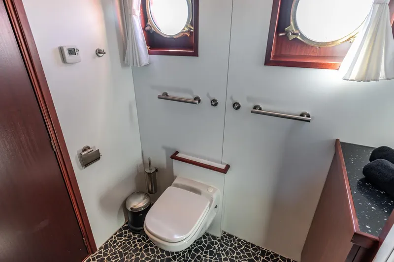 San Gottardo Yacht Photos Pics Bathroom interior of 2009 Altena Expedition yacht with porthole windows and modern fixtures.