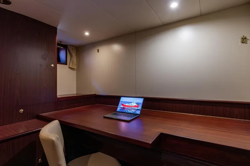 San Gottardo Yacht Photos Pics Luxurious Altena Expedition 2009 yacht interior with wooden desk and laptop.