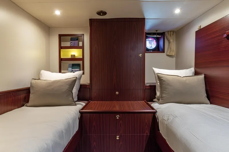 San Gottardo Yacht Photos Pics Luxurious twin cabin interior of 2009 Altena Expedition yacht with wood finish.