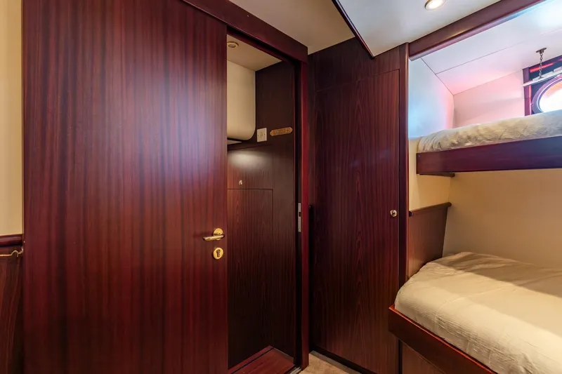 San Gottardo Yacht Photos Pics Interior of 2009 Altena Expedition yacht with wooden doors and bunk beds.