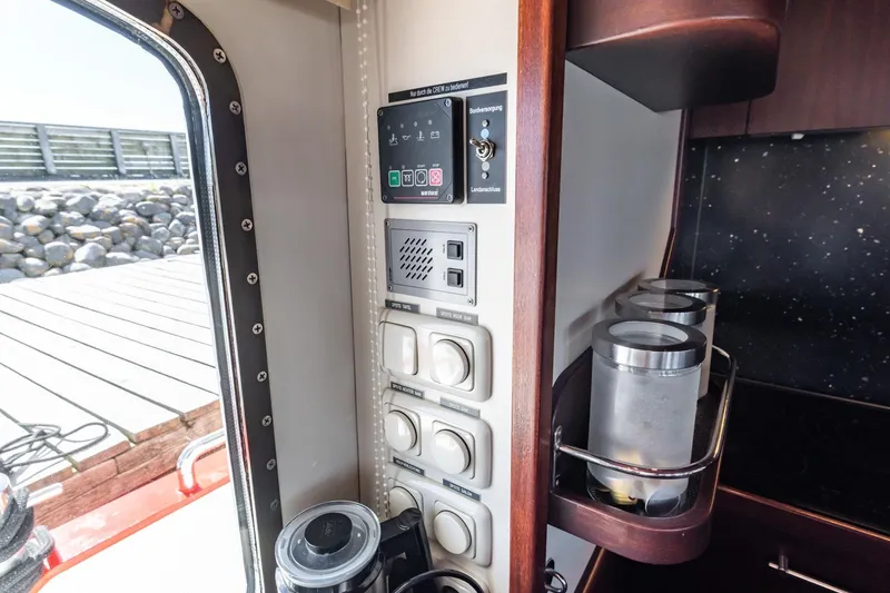 San Gottardo Yacht Photos Pics Control panel inside 2009 Altena Expedition yacht, featuring switches and storage containers.