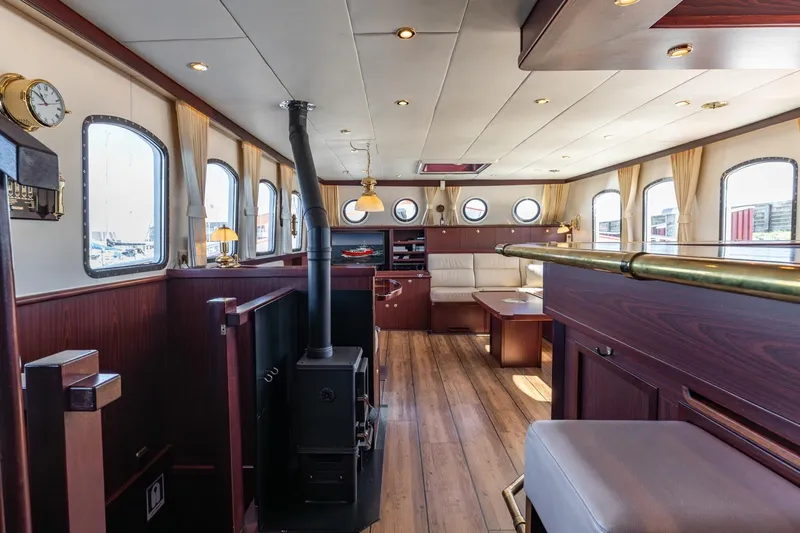 San Gottardo Yacht Photos Pics Luxurious 2009 Altena Expedition yacht interior with wood paneling, cozy seating, and elegant decor.