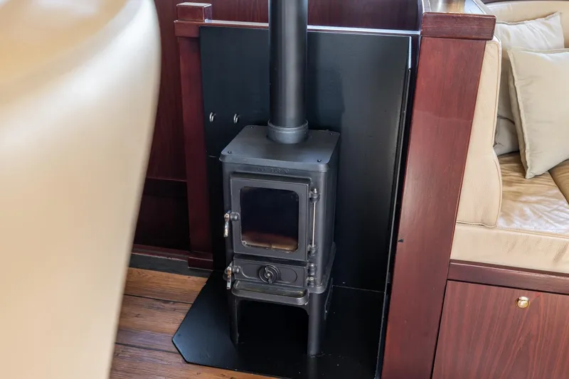 San Gottardo Yacht Photos Pics Wood stove inside 2009 Altena Expedition yacht, with cozy seating and wooden interior.