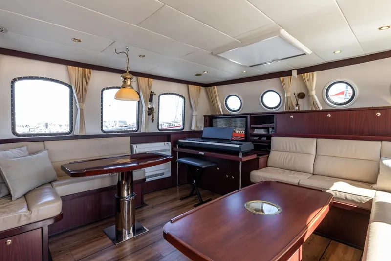 San Gottardo Yacht Photos Pics Luxurious 2009 Altena Expedition yacht interior with elegant seating and wooden furnishings.