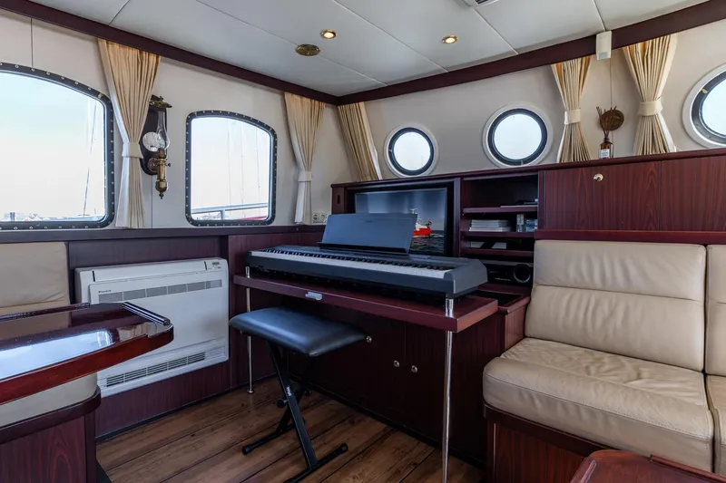 San Gottardo Yacht Photos Pics Luxurious interior of 2009 Altena Expedition yacht with keyboard and elegant seating.