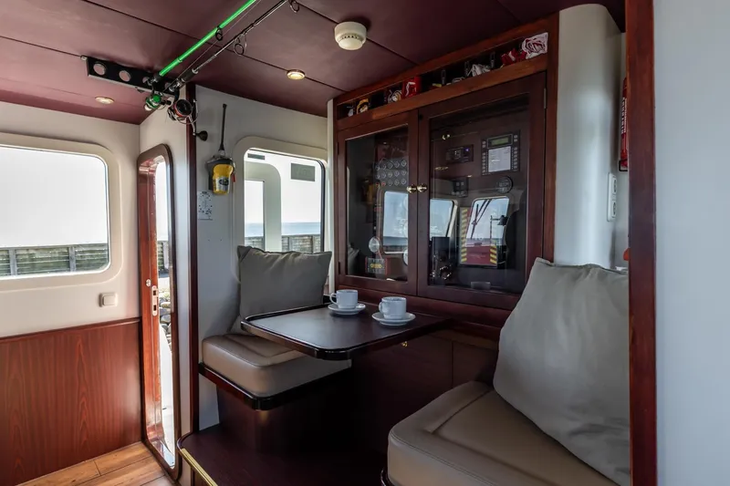 San Gottardo Yacht Photos Pics Interior of 2009 Altena Expedition yacht with cozy seating and wooden cabinetry.