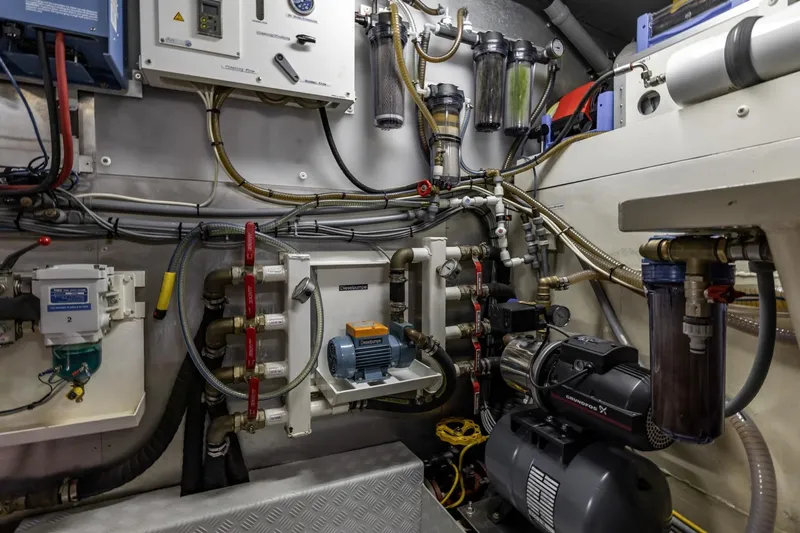 San Gottardo Yacht Photos Pics Engine room of 2009 Altena Expedition yacht with complex machinery and piping systems.