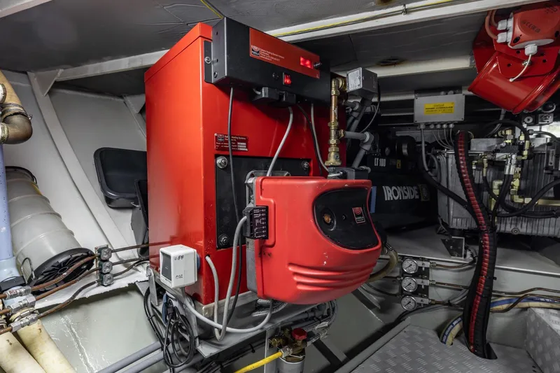 San Gottardo Yacht Photos Pics Engine room of 2009 Altena Expedition yacht with red machinery and complex wiring.