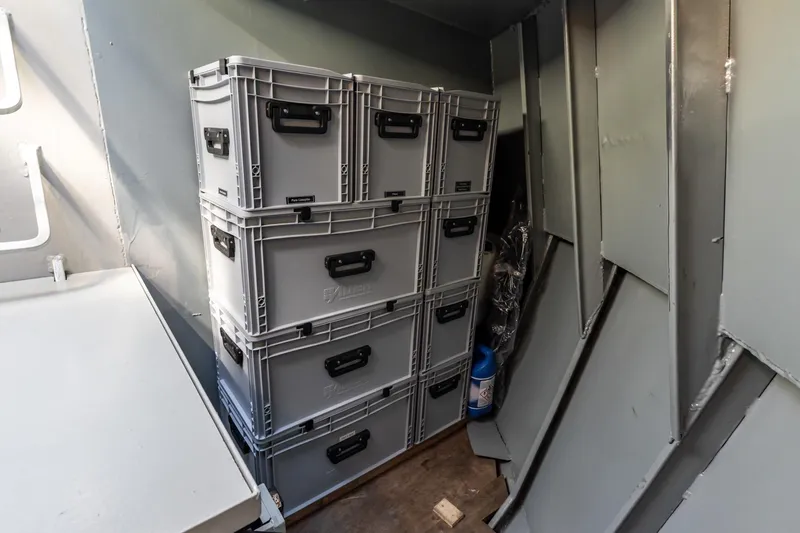San Gottardo Yacht Photos Pics Storage area with stacked gray boxes inside a 2009 Altena Expedition boat.