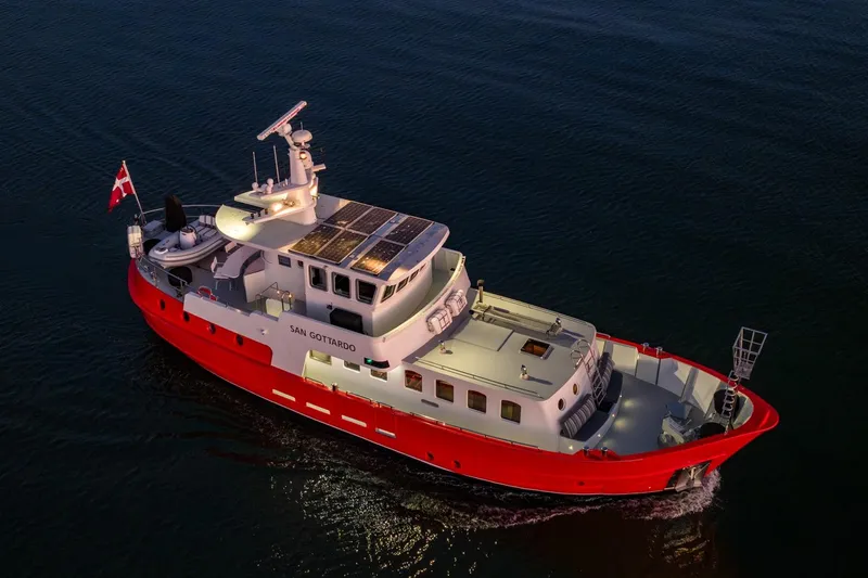 San Gottardo Yacht Photos Pics Red Altena Expedition yacht, 2009 model, cruising on calm waters at dusk.