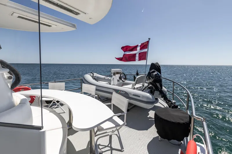 San Gottardo Yacht Photos Pics Luxurious 2009 Altena Expedition yacht deck with seating, Danish flag, and ocean view.
