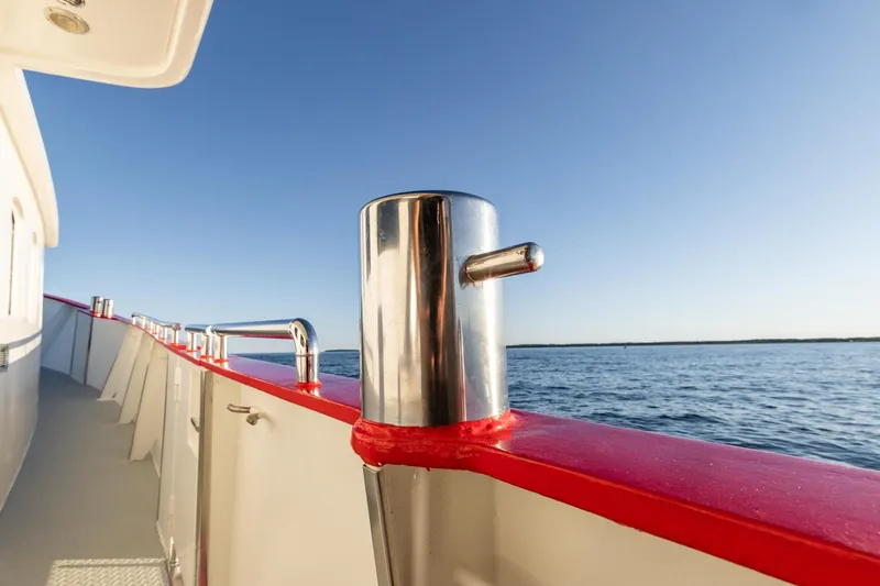 San Gottardo Yacht Photos Pics 2009 Altena Expedition yacht deck with red railing, ocean view, and clear blue sky.