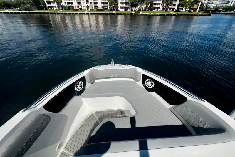  Yacht Photos Pics 2024 NX Boats NX 280 bow view with luxurious seating on calm water.