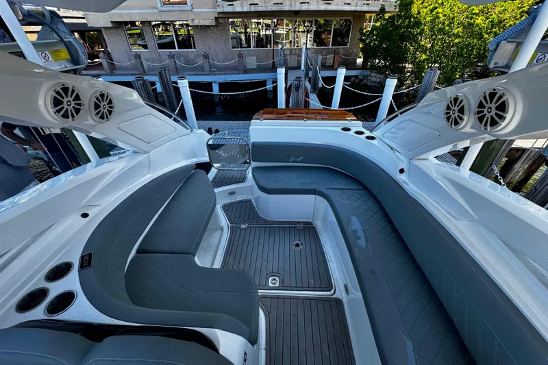  Yacht Photos Pics 2024 NX Boats NX 280 interior with sleek seating and modern design at a dock.