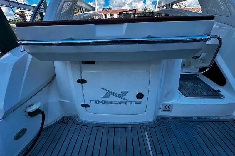  Yacht Photos Pics 2024 NX Boats NX 280, rear view with logo and deck details.
