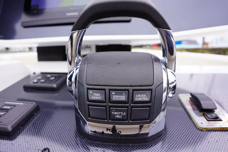 Tender 2 Yacht Photos Pics Close-up of 2020 Novurania Chase boat throttle control with trim assist and cruise control buttons.