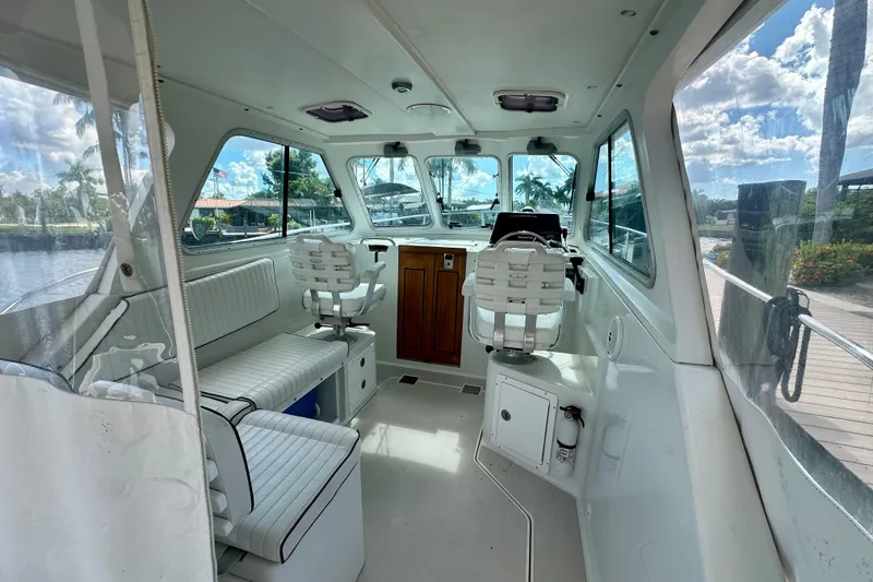  Yacht Photos Pics Interior of a 2006 Back Cove 29 boat with seating and helm station.