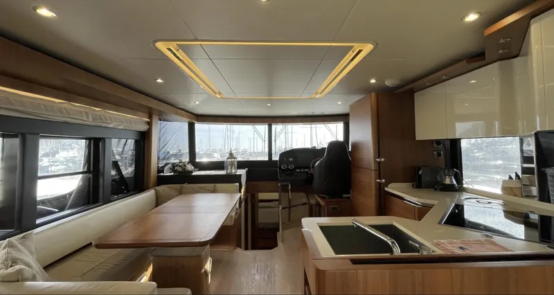 Grace Yacht Photos Pics Luxurious interior of 2016 Absolute NAVETTA 58 yacht with modern kitchen and seating area.