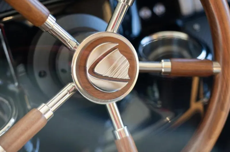 Grace Yacht Photos Pics Steering wheel of 2016 Absolute NAVETTA 58 yacht, featuring wood and metal design.