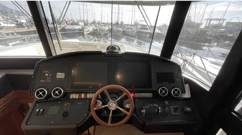 Grace Yacht Photos Pics Cockpit view of 2016 Absolute NAVETTA 58 yacht with marina in background.