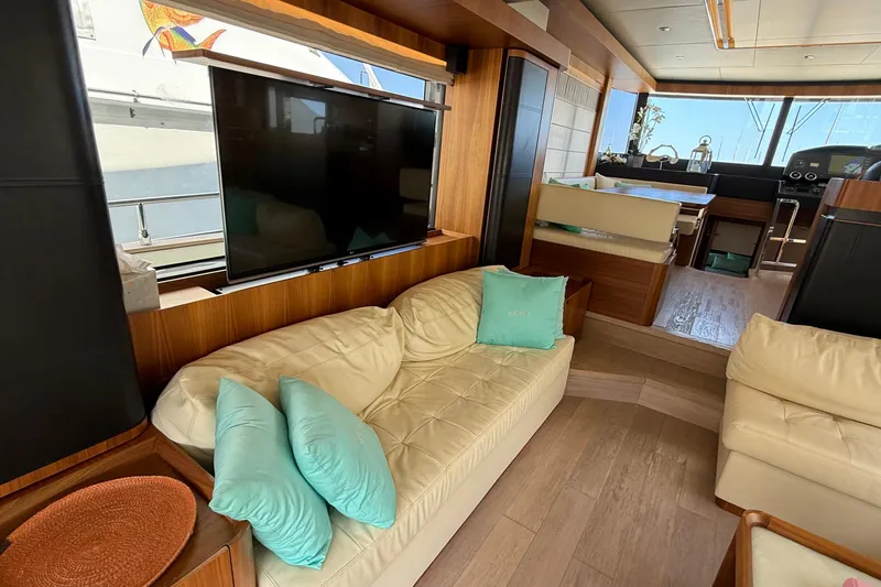 Grace Yacht Photos Pics Luxurious interior of 2016 Absolute NAVETTA 58 yacht with plush seating and large TV.