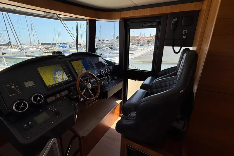 Grace Yacht Photos Pics Interior helm of 2016 Absolute NAVETTA 58 yacht with navigation screens and leather seats.