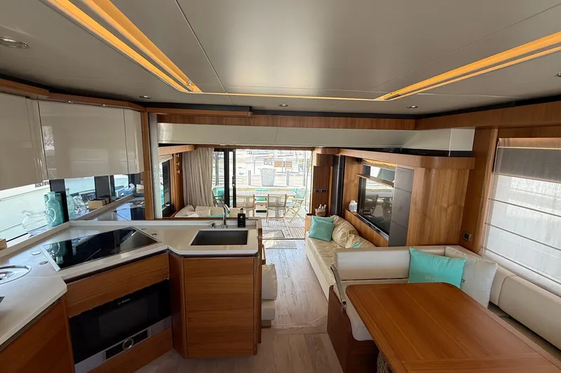 Grace Yacht Photos Pics Luxurious interior of 2016 Absolute NAVETTA 58 yacht with modern kitchen and seating area.