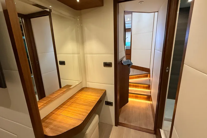 Grace Yacht Photos Pics Luxurious interior of 2016 Absolute NAVETTA 58 yacht with wooden accents and illuminated stairs.