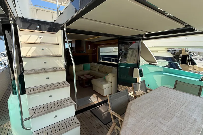 Grace Yacht Photos Pics Luxurious 2016 Absolute NAVETTA 58 yacht interior with stairs, seating, and dining area.