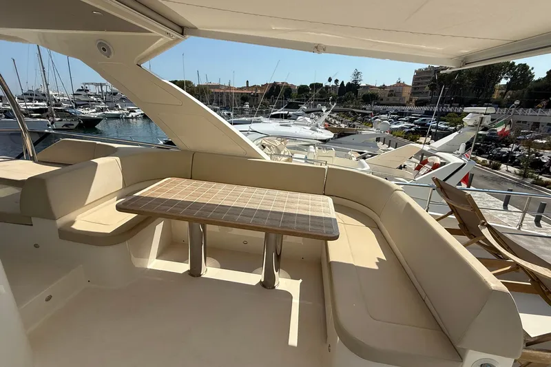 Grace Yacht Photos Pics Luxurious seating area on 2016 Absolute NAVETTA 58 yacht, docked at a marina.