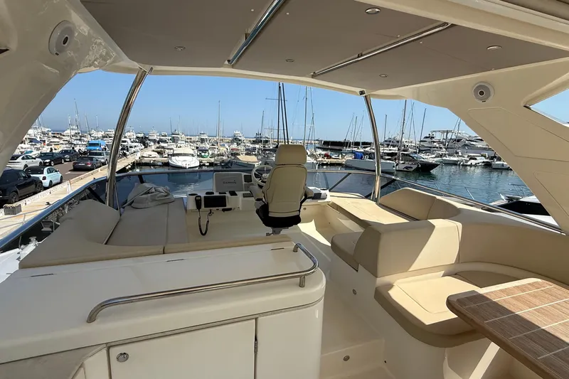 Grace Yacht Photos Pics Luxurious 2016 Absolute NAVETTA 58 yacht interior at marina, featuring elegant seating and helm.