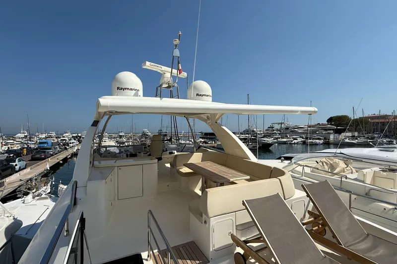 Grace Yacht Photos Pics Luxurious 2016 Absolute NAVETTA 58 yacht docked at a marina, featuring spacious deck seating.