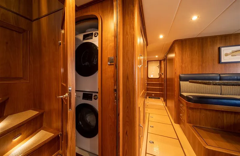 Julianne (name Reserved) Yacht Photos Pics Luxurious interior of 2022 Outer Reef Yachts 900 Motoryacht with wood paneling and laundry area.