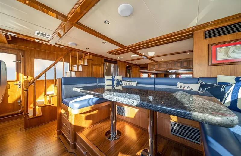 Julianne (name Reserved) Yacht Photos Pics Luxurious interior of 2022 Outer Reef Yachts 900 Motoryacht with elegant wood and blue seating.