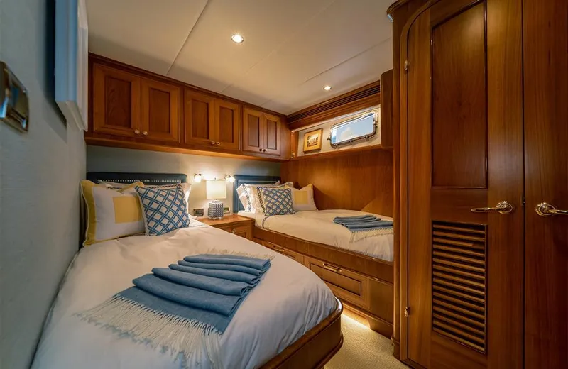 Julianne (name Reserved) Yacht Photos Pics Luxurious twin cabin in 2022 Outer Reef Yachts 900 Motoryacht, featuring elegant wood finishes.