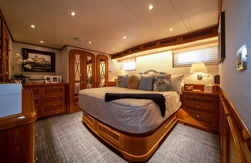 Julianne (name Reserved) Yacht Photos Pics Luxurious bedroom interior of 2022 Outer Reef Yachts 900 Motoryacht with elegant wood finishes.