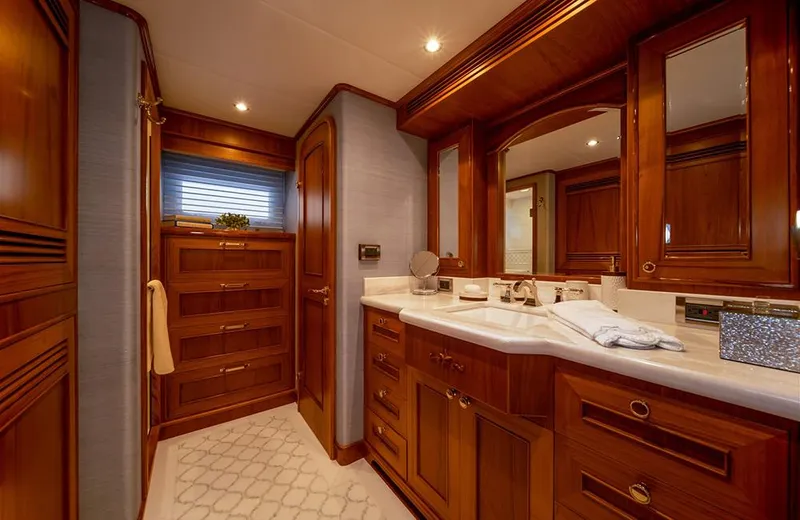 Julianne (name Reserved) Yacht Photos Pics Luxurious bathroom interior of 2022 Outer Reef Yachts 900 Motoryacht with wooden cabinetry and elegant fixtures.