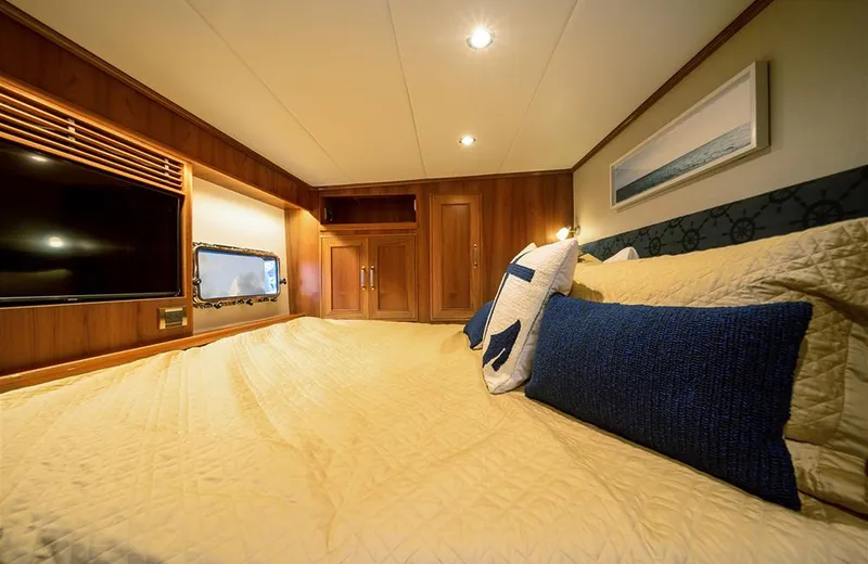 Julianne (name Reserved) Yacht Photos Pics Luxurious bedroom in 2022 Outer Reef Yachts 900 Motoryacht with cozy bedding and elegant wood finishes.