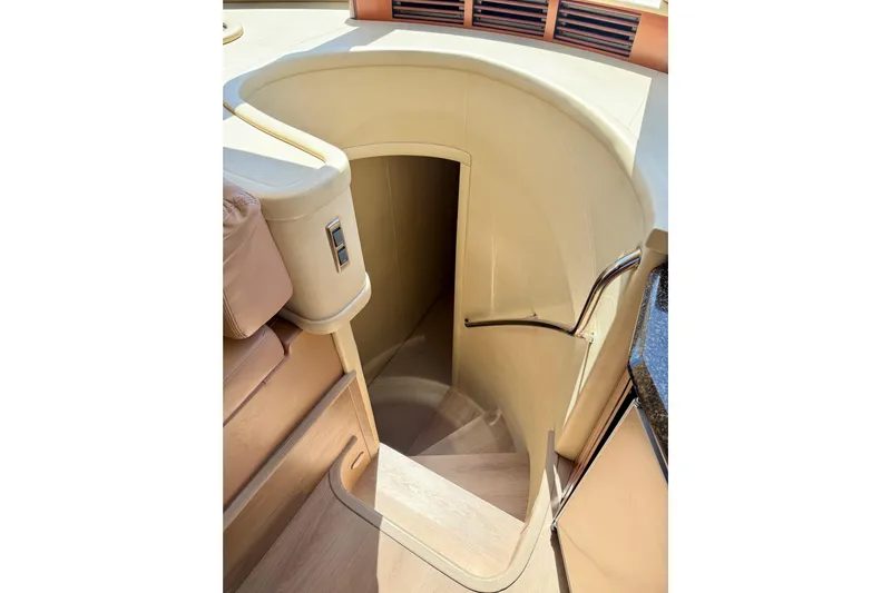 Ponchonchos Yacht Photos Pics Interior staircase of 2005 Sea Ray 550 Sedan Bridge yacht, featuring elegant design and wood finish.