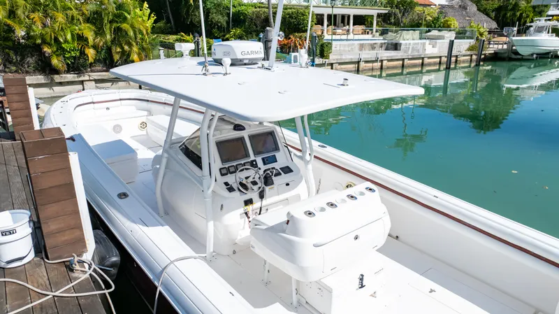  Yacht Photos Pics 2012 Intrepid 400 Center Console boat docked by a serene waterfront.