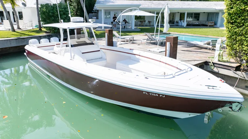  Yacht Photos Pics 2012 Intrepid 400 Center Console boat docked by a waterfront home.