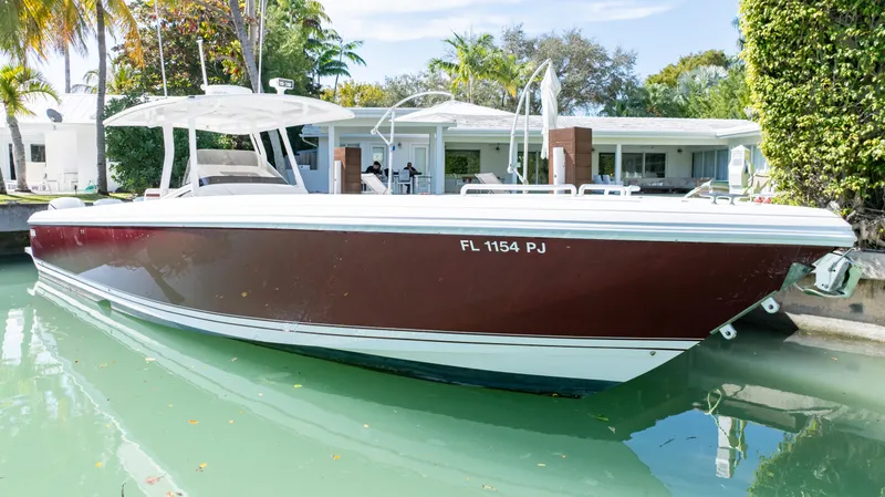  Yacht Photos Pics 2012 Intrepid 400 Center Console boat docked in a serene canal setting.