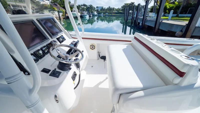  Yacht Photos Pics 2012 Intrepid 400 Center Console boat interior with steering wheel and seating, docked by calm water.