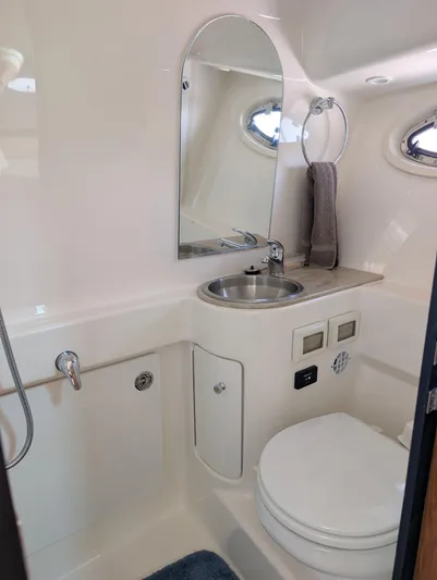 Finale Yacht Photos Pics 2015 Tiara Yachts 3100 Open bathroom with sink, mirror, and toilet.